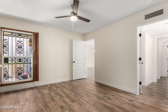 unfurnished room with dark hardwood / wood-style floors and ceiling fan