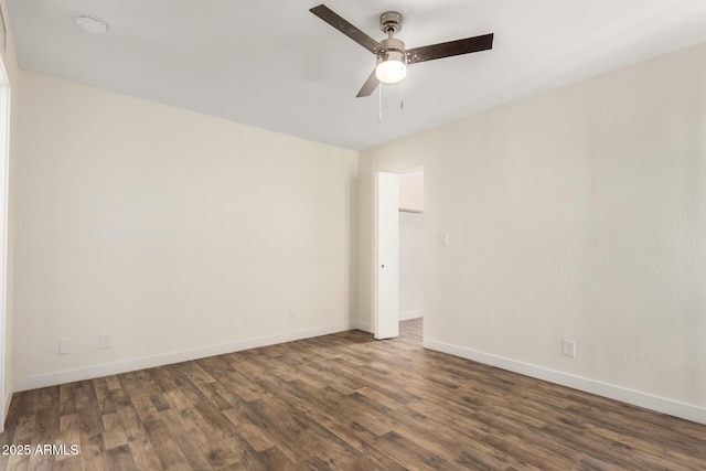 empty room with ceiling fan and dark hardwood / wood-style floors