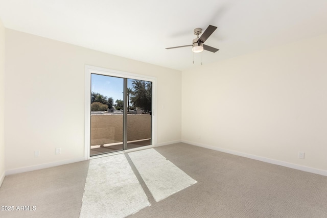 carpeted spare room with ceiling fan