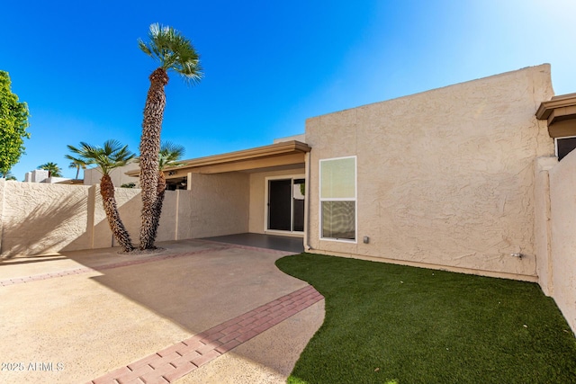 back of property with a patio