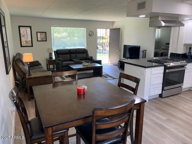 dining space featuring light wood-type flooring