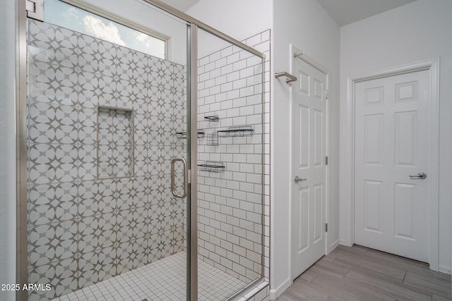 bathroom featuring hardwood / wood-style floors and walk in shower