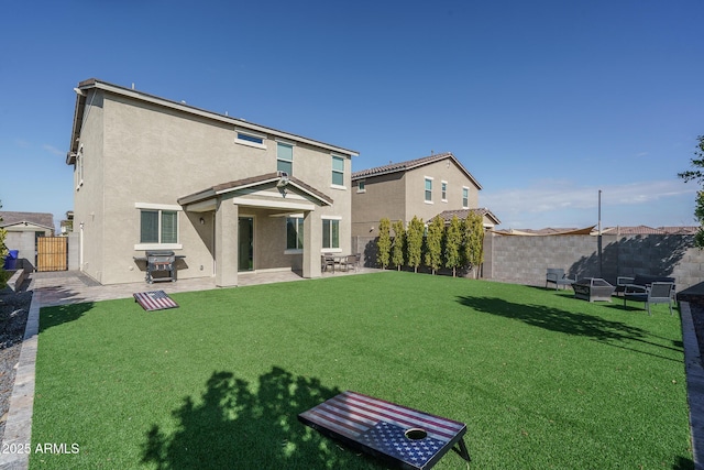 back of house with a yard and a patio area