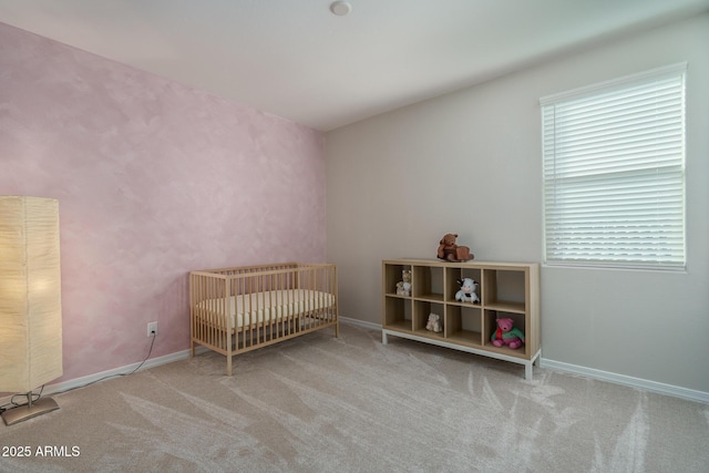 bedroom featuring light carpet and a crib