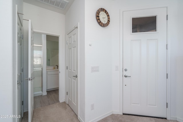 hall with light colored carpet