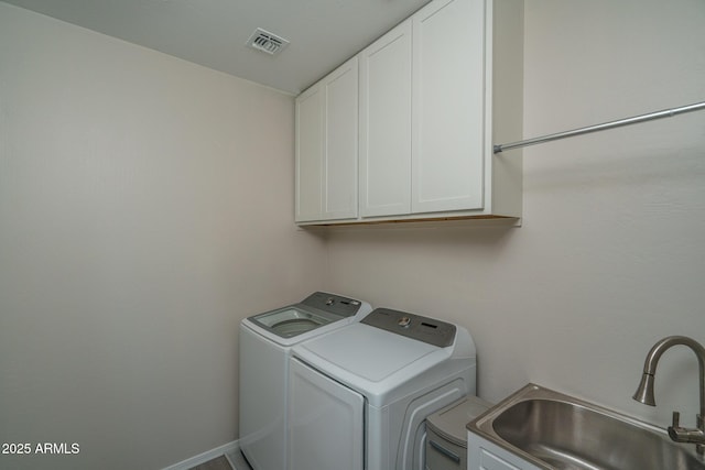 laundry room featuring cabinets, sink, and washer and dryer