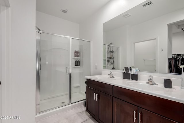3670 E Sandoval Dr, San Tan Valley, AZ 85140 - bathroom featuring a shower stall, double vanity, visible vents, and a sink