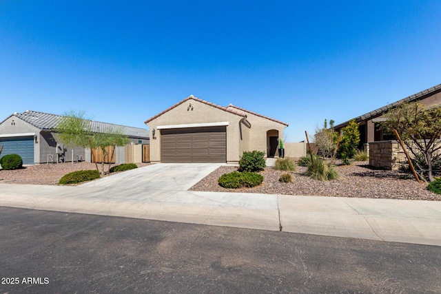 3670 E Sandoval Dr, San Tan Valley, AZ 85140 - view of front facade featuring concrete driveway, stucco siding, fence, an attached garage, and a tiled roof