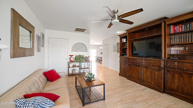 living room featuring ceiling fan and light hardwood / wood-style flooring