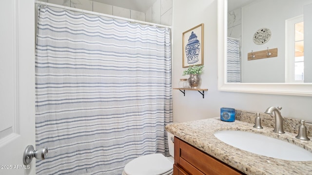 bathroom with a shower with curtain, vanity, and toilet