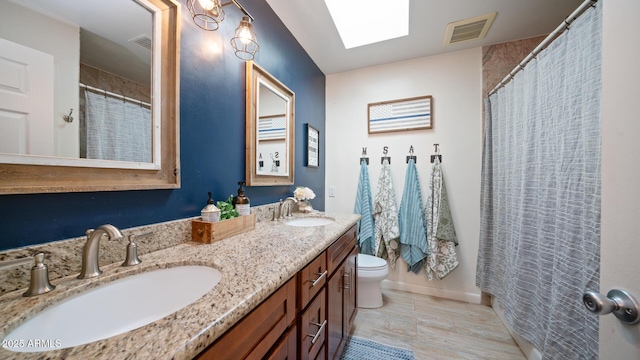 bathroom with vanity, toilet, and walk in shower