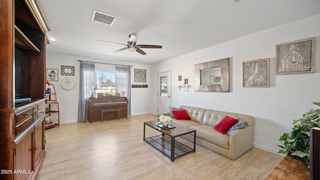 living room featuring ceiling fan and light wood-type flooring