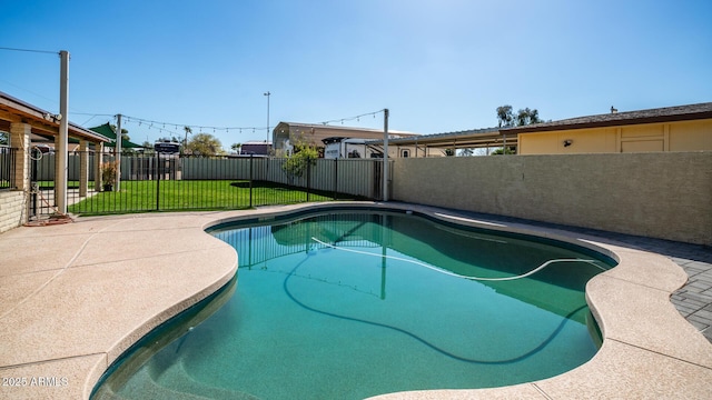 view of pool with a yard and a patio