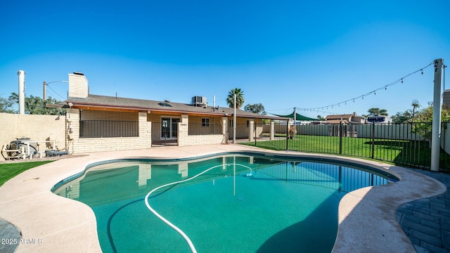 view of swimming pool with a yard and a patio