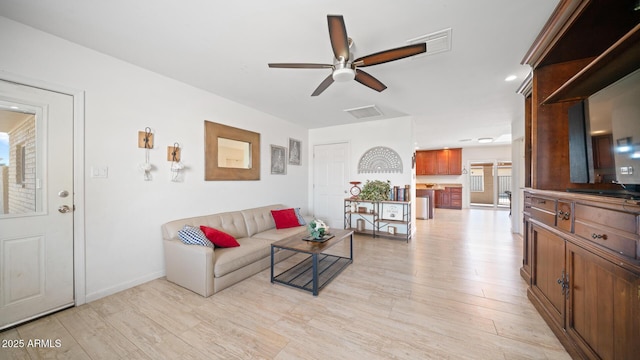 living room with light hardwood / wood-style flooring and ceiling fan