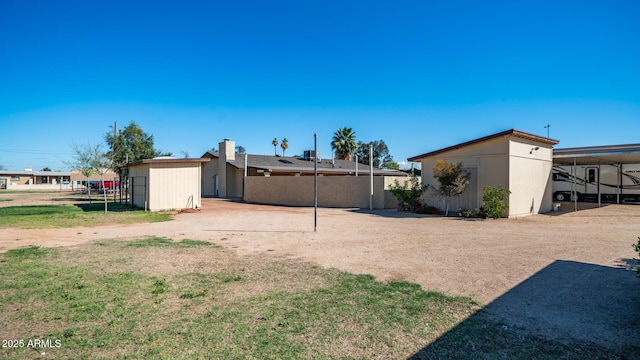 view of yard featuring an outdoor structure and a carport