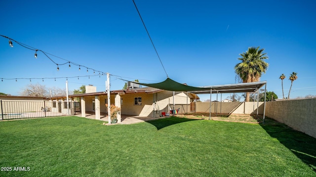 back of house with a lawn and a patio