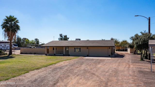 ranch-style home with a garage and a front yard