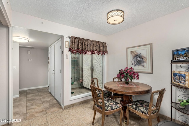 dining space featuring a textured ceiling