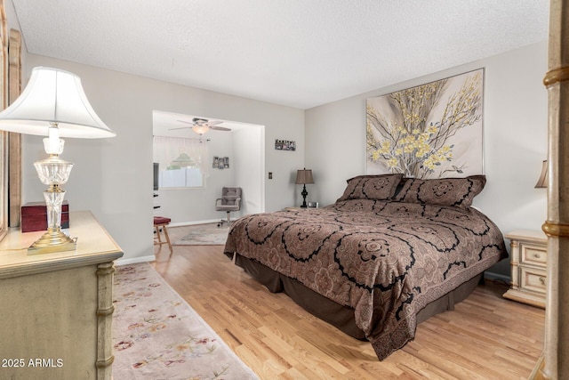 bedroom featuring a textured ceiling and light hardwood / wood-style floors