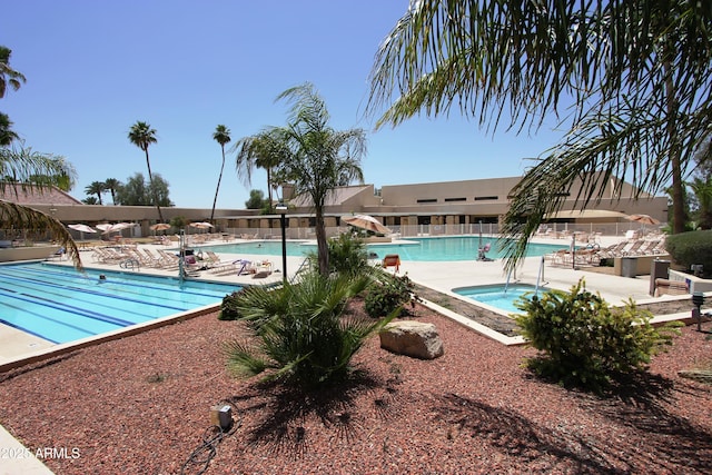 view of swimming pool with a community hot tub and a patio