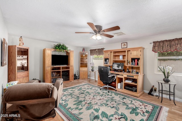 office space featuring ceiling fan, a textured ceiling, and light hardwood / wood-style floors