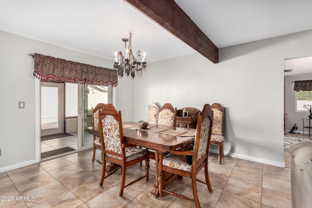 tiled dining space with beamed ceiling, plenty of natural light, a textured ceiling, and a notable chandelier