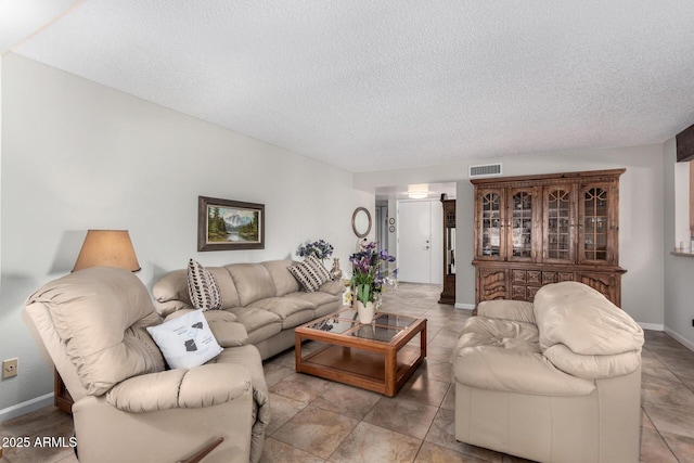 living room with light tile patterned floors and a textured ceiling