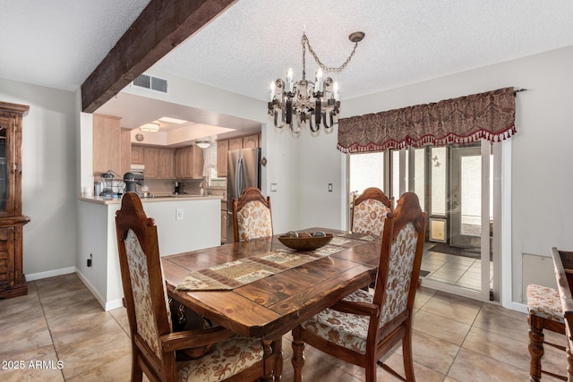 tiled dining room featuring an inviting chandelier, beam ceiling, sink, and a textured ceiling