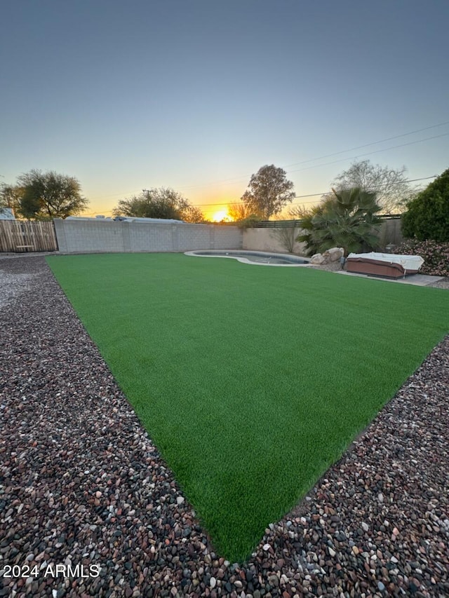 view of yard at dusk