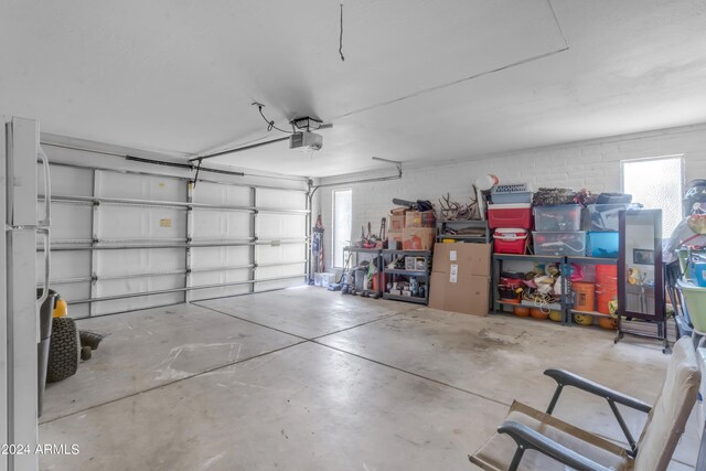 garage with a garage door opener and white refrigerator