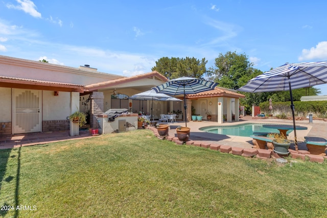 view of pool featuring grilling area, a yard, and a patio