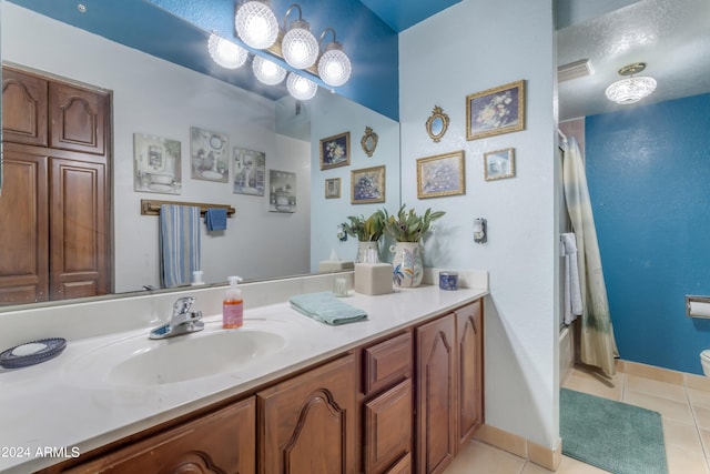 full bathroom with shower / bath combo with shower curtain, tile patterned flooring, toilet, and vanity