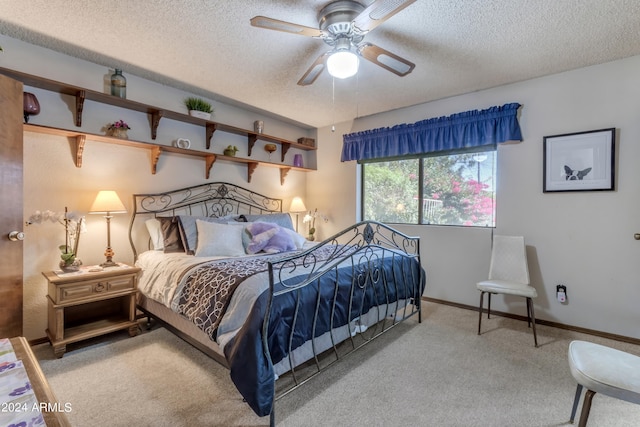 bedroom featuring a textured ceiling, ceiling fan, and carpet floors