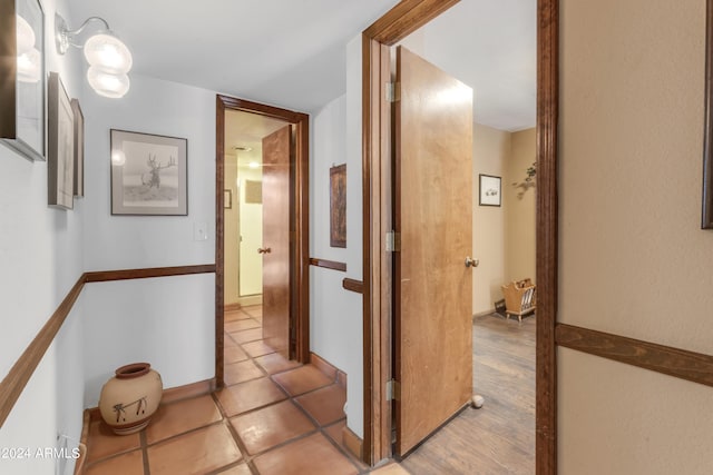 hall featuring light tile patterned floors