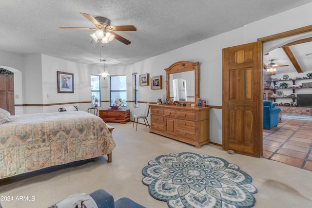 bedroom with a textured ceiling, light colored carpet, ceiling fan, and beam ceiling