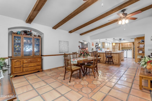 tiled dining area featuring separate washer and dryer, lofted ceiling with beams, and ceiling fan