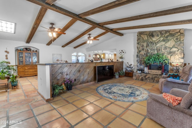 living room featuring a fireplace, beamed ceiling, ceiling fan, light tile patterned flooring, and high vaulted ceiling