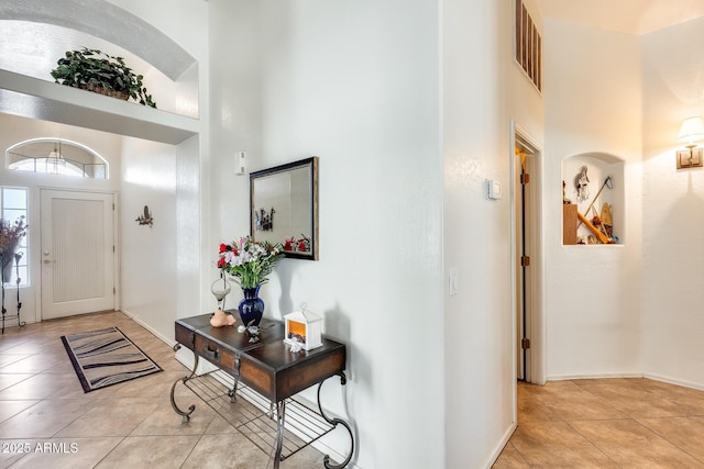 tiled foyer entrance with a high ceiling