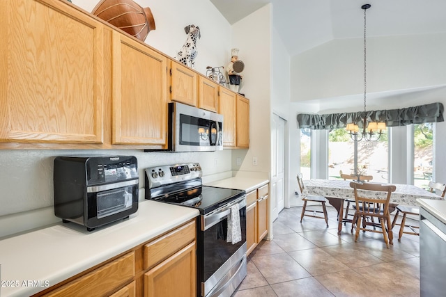 kitchen with pendant lighting, light brown cabinetry, light tile patterned floors, stainless steel appliances, and an inviting chandelier