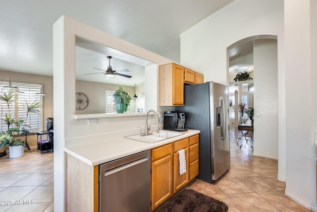 kitchen featuring light tile patterned flooring, ceiling fan, stainless steel appliances, and sink