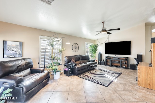 tiled living room featuring ceiling fan and lofted ceiling