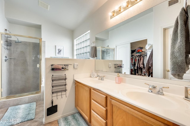 bathroom with vanity, an enclosed shower, and tile patterned flooring