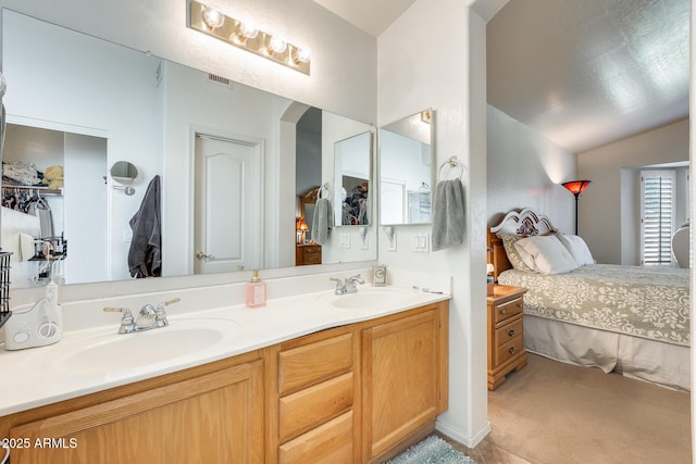 bathroom with lofted ceiling and vanity