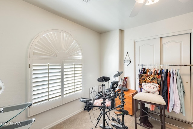 interior space featuring carpet floors and ceiling fan