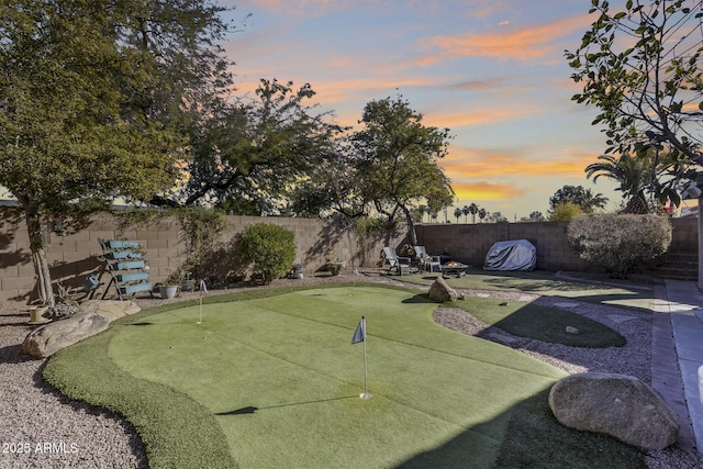 yard at dusk featuring a patio