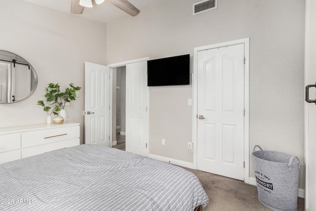 bedroom with carpet floors, visible vents, baseboards, and a ceiling fan