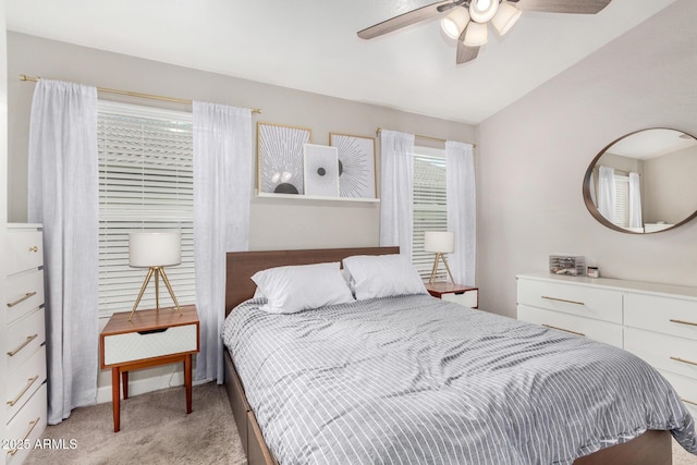 bedroom with light carpet, lofted ceiling, and a ceiling fan