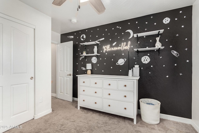 bedroom with light carpet and baseboards