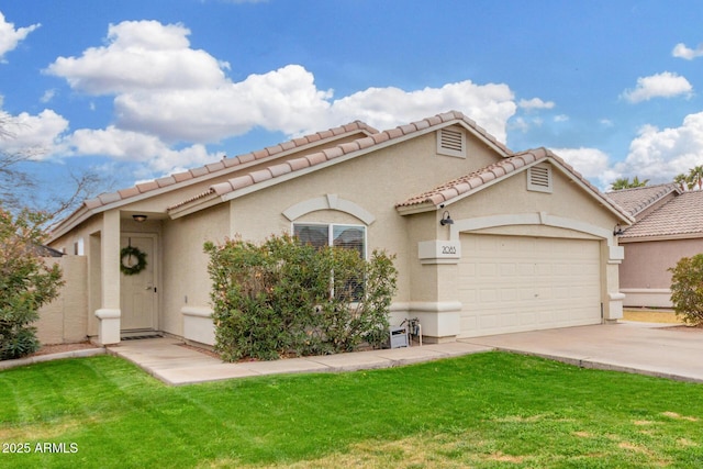 mediterranean / spanish home with driveway, a front lawn, an attached garage, and stucco siding